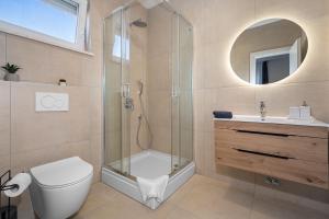 a bathroom with a shower and a toilet and a sink at Villa Vallis in Nedeščina +7 photos