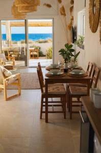 a dining room with a table and a view of the ocean at Cozy beach house in Perivolia