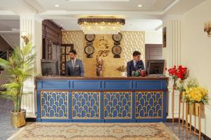 two men standing at a blue bar in a room at Falettis Grand Hotel Naran in Naran +16 photos