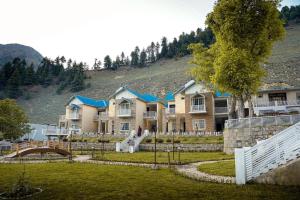 a large house with a fence in front of it at Falettis Grand Hotel Naran in Naran