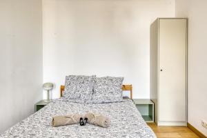 a bed with a pair of shoes sitting on it at Le Palacio in Saint-Denis