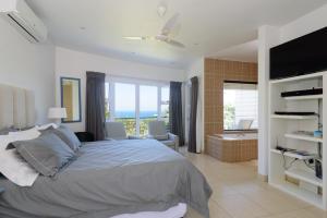a bedroom with a large bed and a bathroom at San Maarten 12 in Sheffield Beach +12 photos