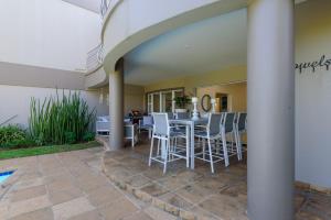 a patio with a table and chairs in a house at San Maarten 12 in Sheffield Beach