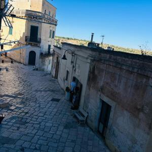 an alley with a bench next to a building at Santa Cesarea Sassi in Matera