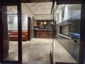a lobby with a couch and a bar in a building at Hotel Metro Palace L&B in Panvel