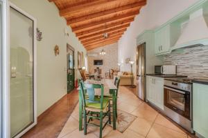 a kitchen with a table and chairs in a room at Archontiko Loukis in Pentátion