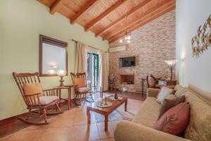 a living room with a couch and chairs and a fireplace at Archontiko Loukis in Pentátion