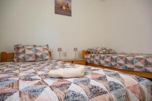 a bedroom with two beds and a pillow on a bed at Apartman Sofija Palić in Palić