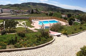 a resort with a swimming pool and a garden at Domestival in Vila Verde dos Francos
