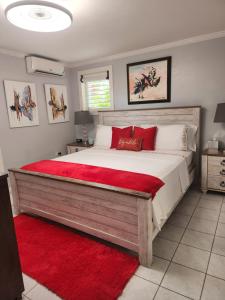 a bedroom with a large bed with red pillows at Millsborough B&B in Billy Dun +11 photos