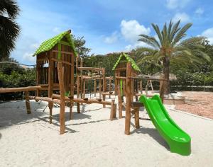 a group of playground equipment in the sand at Tropical Beach Villa with Ocean View in Blue Bay
