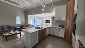a kitchen and living room with a couch at Ocean Whisper in Velddrif