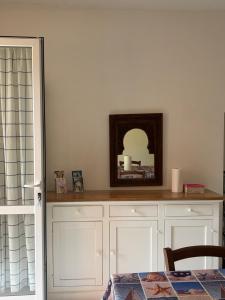 a mirror sitting on top of a white cabinet at Casa Mare Blu codice CITRA OO9O34 LT 1168 in Loano +2 photos
