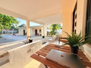 a laptop computer sitting on a wooden bench on a porch at Lyric and Melody Collection in Santa Catalina