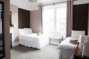 a bedroom with two beds and a window at Ship Inn in Wylam