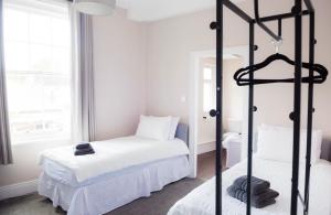 a bedroom with two beds with white sheets at Ship Inn in Wylam +3 photos