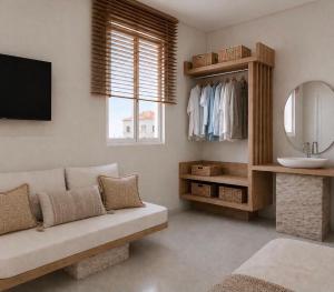 a living room with a couch and a mirror at Sea Lily Suites Milos in Paleochori +10 photos