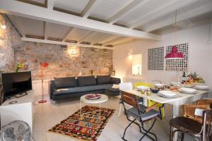 a living room with a couch and a table at Charming Stone House with Green Courtyard in Stari Grad