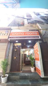 a doorway to a building with a sign for a women rooms at Wama Rooms in New Delhi