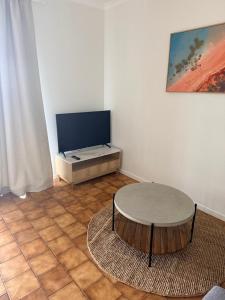 a living room with a table and a tv at Valley View House in Gympie +11 photos