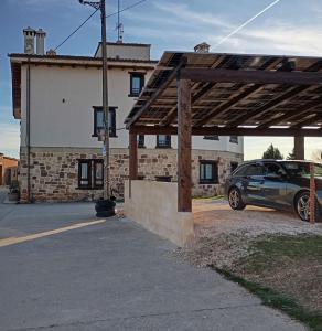 a car parked in a parking lot in front of a building at Hotel Valdelinares (Soria) in Valdelinares