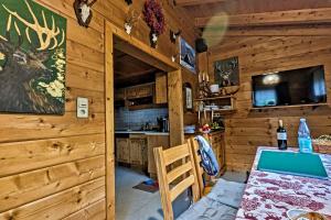 a dining room and kitchen in a log cabin at Almchalet Goldbergleiten in Großkirchheim