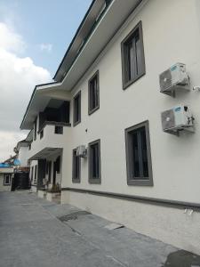 a white building with windows and air conditioners at JKB PREMIUM lUXURY in Lekki