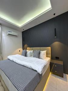 a bedroom with a large bed with white sheets at JKB PREMIUM lUXURY in Lekki +12 photos