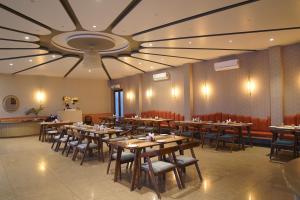 a dining room with tables and chairs and a ceiling at KMR Hotels & Resorts in Bikaner