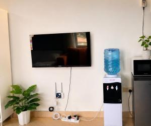 a television on a wall with a water bottle on top at Studio in kilifi close to beach and supermarket in Kilifi