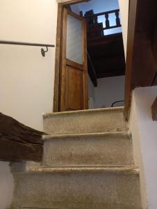 an open door leading up to a stairway at La Loggetta in Bagnaia