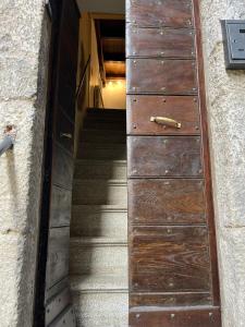 a wooden door with a staircase leading up to a building at La Loggetta in Bagnaia