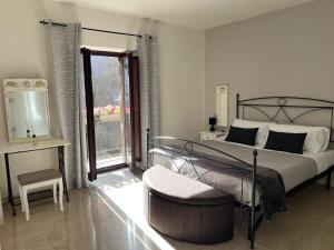 a bedroom with a bed and a chair and a window at La Loggetta in Bagnaia +17 photos