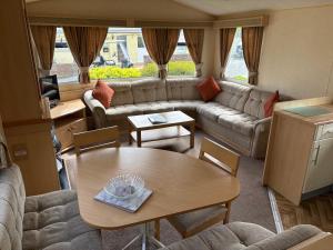 a living room with a couch and a table at 19 Vale Park in Fishguard