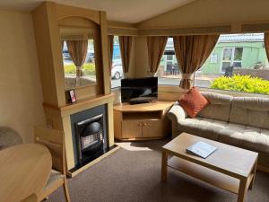 a living room with a couch and a fireplace at 19 Vale Park in Fishguard