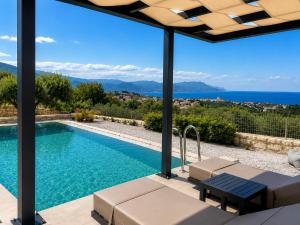 a swimming pool with a view of the ocean at Casa Ydor in Koúfi
