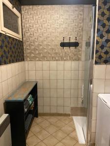 a small bathroom with a shower and a sink at Le temps d'une pause bed and breakfast in Servance