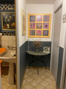 a bathroom with a sink and a table in it at Le temps d'une pause bed and breakfast in Servance +11 photos