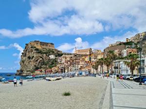a beach in positano with a mountain in the background at Alba Mediterranea in Reggio di Calabria