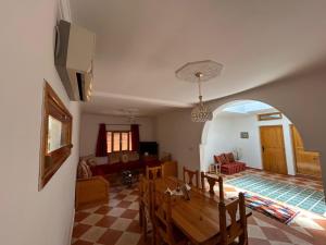 a living room with a table and a couch at Peaceful Retreat in Oulad Akkou +47 photos