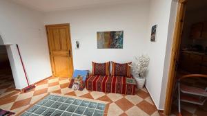 a living room with a couch and a floor at Peaceful Retreat in Oulad Akkou