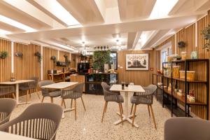 a restaurant with wooden walls and tables and chairs at Garden Hotel in Zagreb