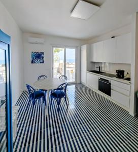 a kitchen with a table and chairs in a room at Minnelea Blue Retreat in Acciaroli