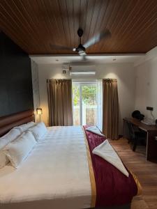 a bedroom with a large bed and a window at Casa Marina Beachfront Resort in Padubidri +48 photos
