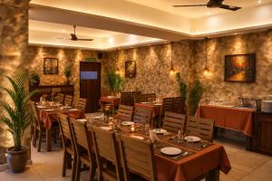 a restaurant with tables and chairs in a room at Pleasant Hill Resort - Munnar in Munnar