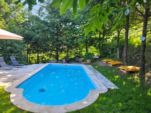 a swimming pool in a yard with chairs and trees at Moose House EV Charging Pool Gated Community in Loivos
