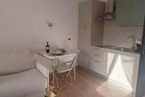 a small kitchen with a table and a white couch at Torre del Borgo - Centro Storico di Accettura in Accettura
