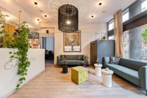 a lobby with couches and a table in a room at Garden Hotel in Zagreb