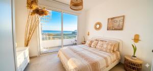 a bedroom with a bed and a large window at Cozy beach house in Perivolia