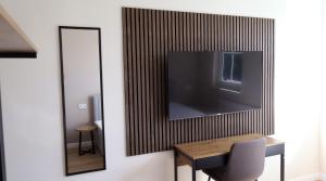 a dining room with a table and a mirror at Hotel NeckarOase in Lauffen am Neckar